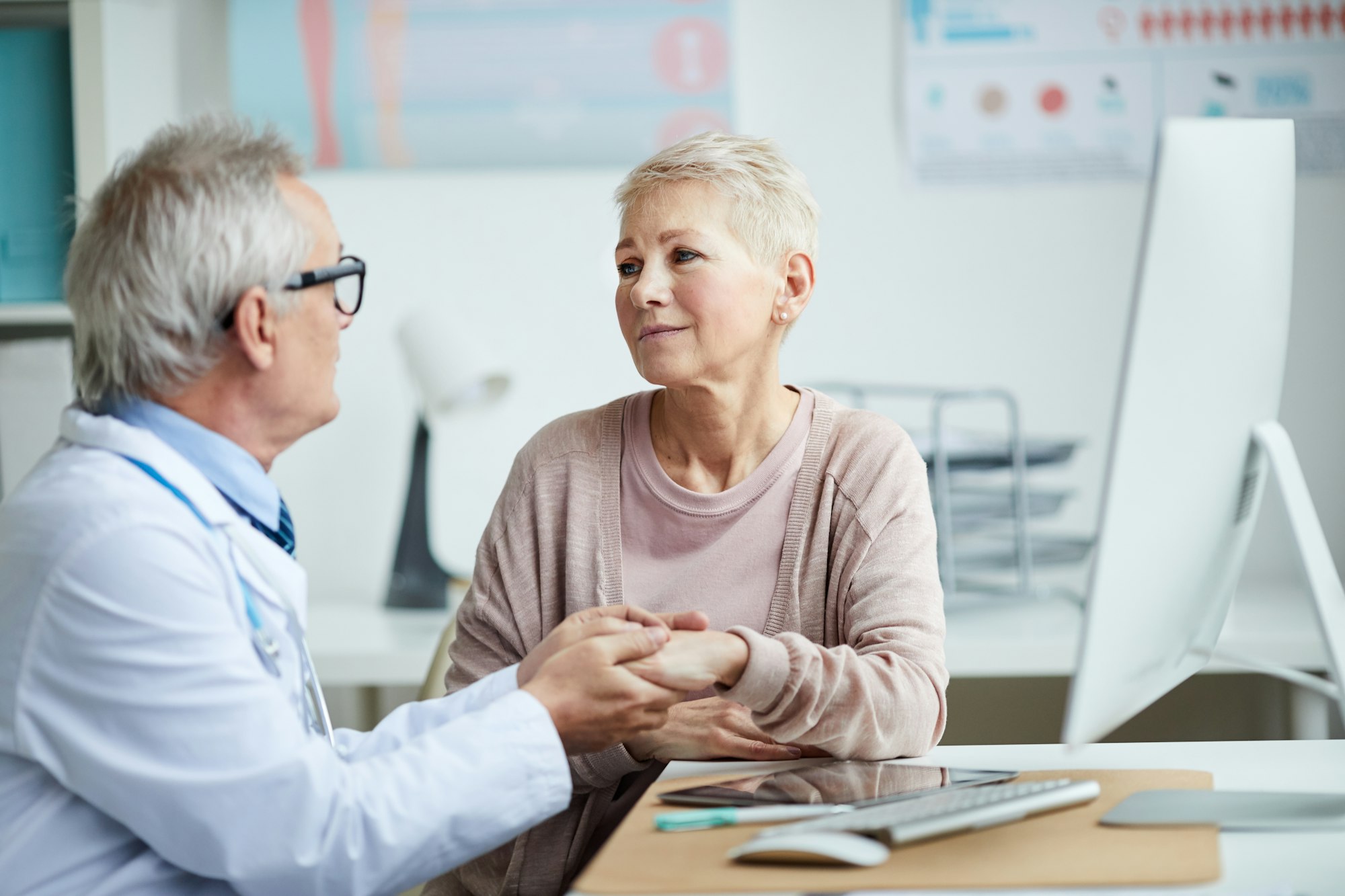 Senior doctor giving hope and comfort to patient