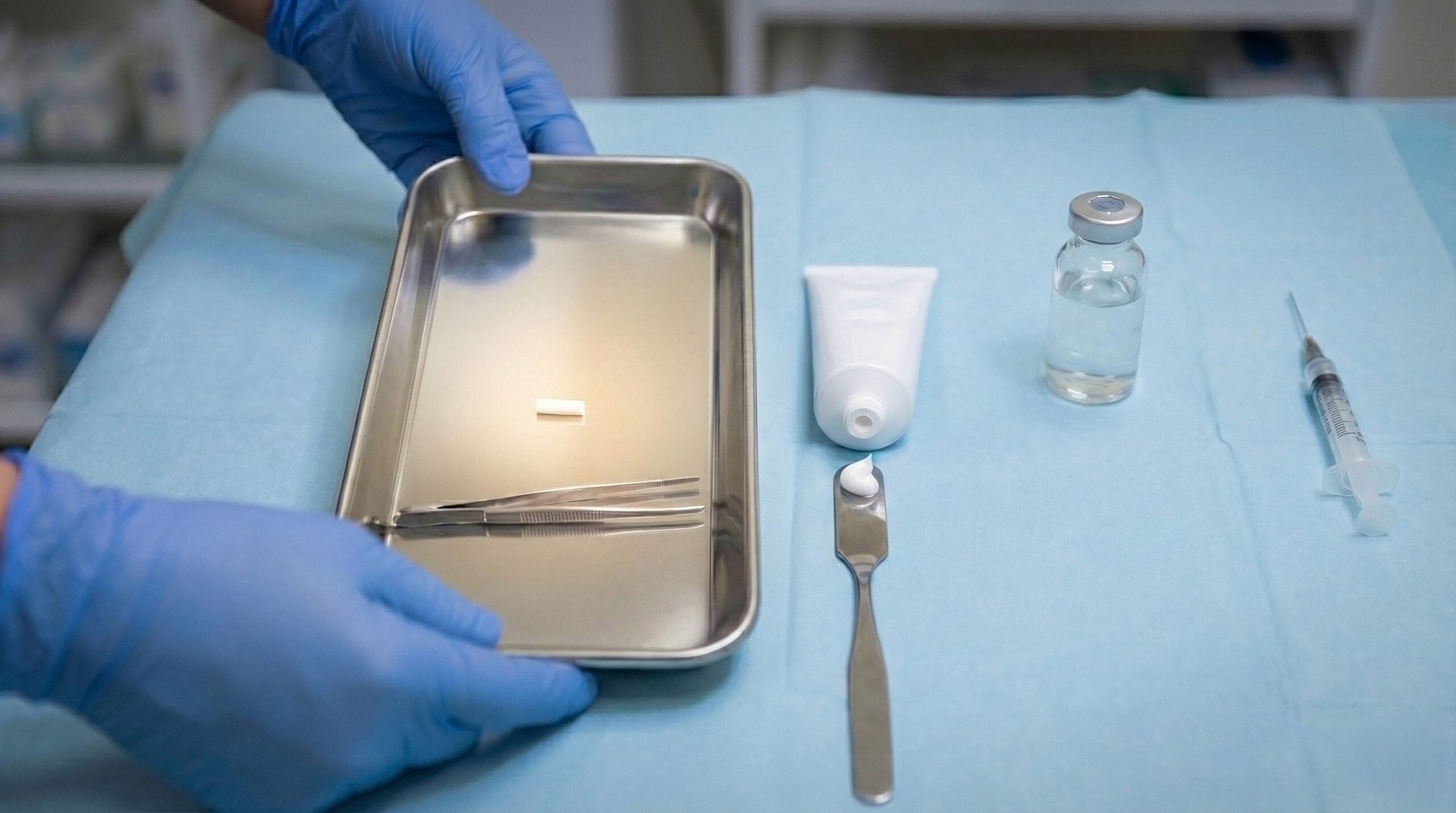 Comparison of B-HRT delivery methods showing hormone pellets, a tube of topical cream, and an injection syringe on a medical tray.